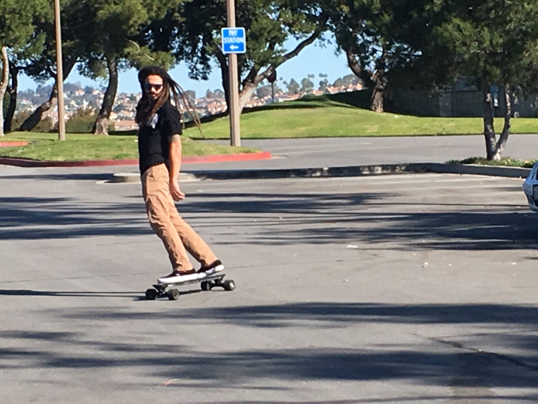 Man on electric longboard in the street